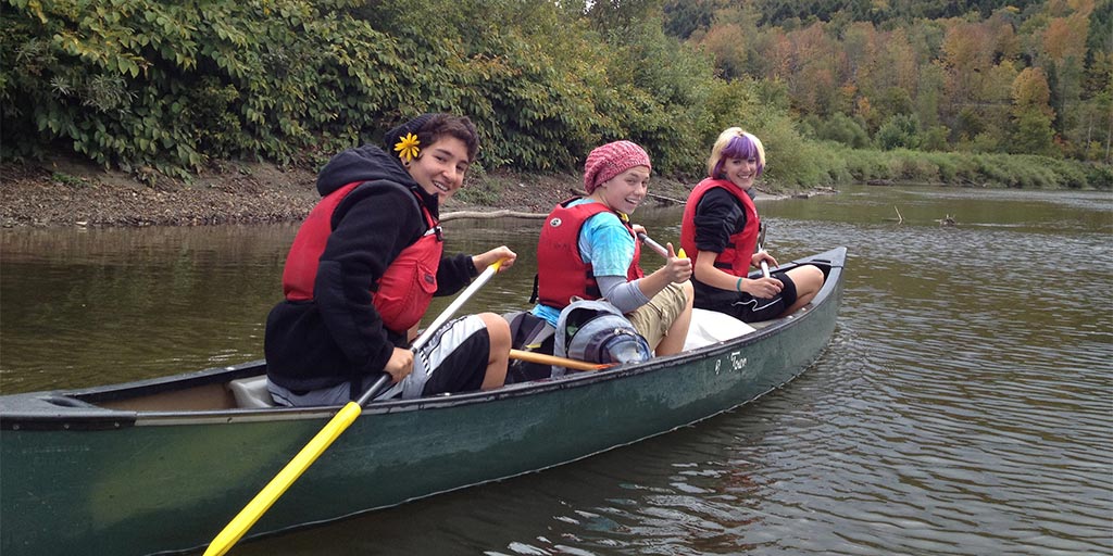 Students enjoy paddling down the river