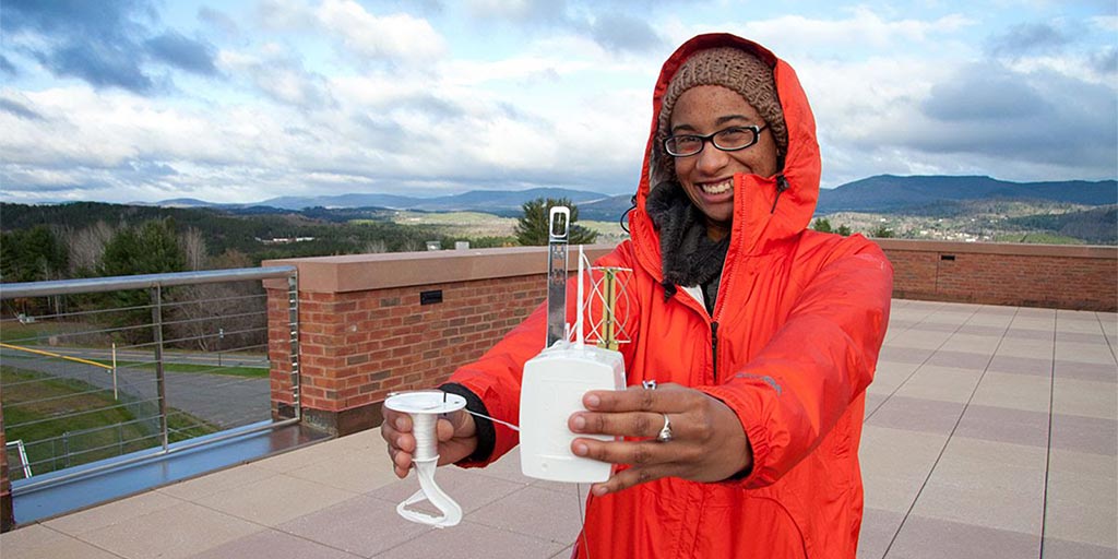 Atmospheric Sciences student prepares device for balloon launch