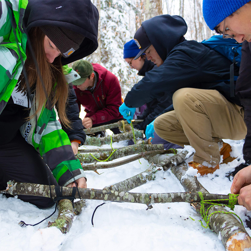 Students practicing wilderness first aid in the snow