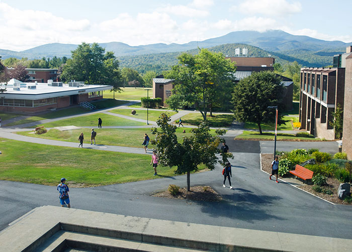 An overhead view of a college campus, with students walking along paths.