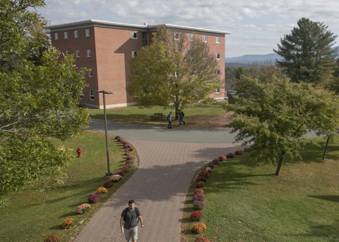 Students walking outside of a college campus building.