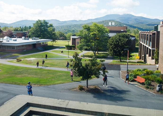 An overhead view of a college campus, with students walking on paths.